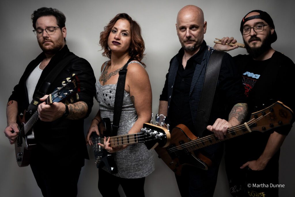 A group shot of the members of Bellwether Ritual posing with their guitars