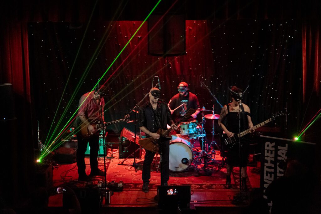 Bellwether Ritual wearing masks on stage at The Gem