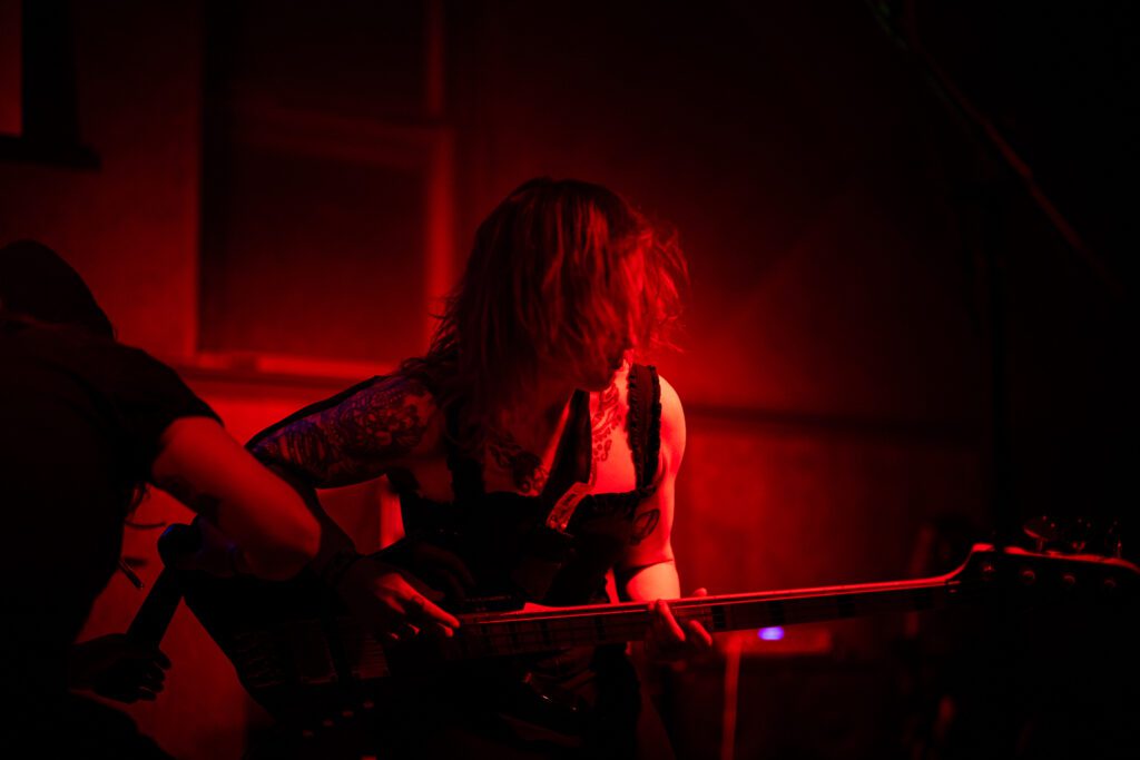 Hilary playing bass at Sokols with red light